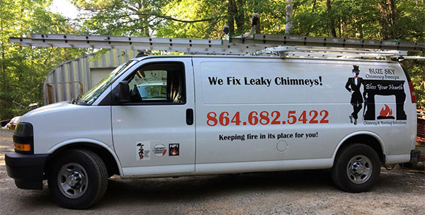 Blue Sky Chimney Van white with logo on the side and ladder on top.  It says "We Fix Leaky Chimneys!" and has the phone number 864-682-5422